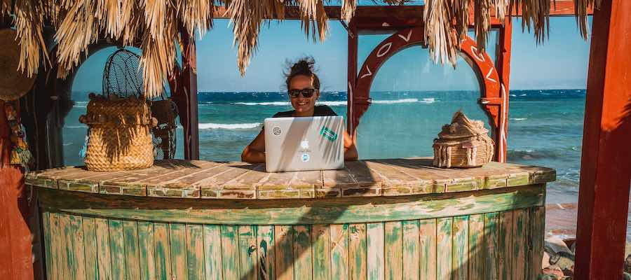 digital nomad working from the beach